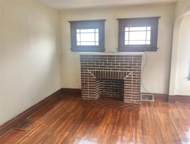 11 Verdun Ave, Buffalo, NY 14214 - unfurnished living room featuring a tile fireplace, dark wood-style flooring, baseboards, and healthy amount of natural light