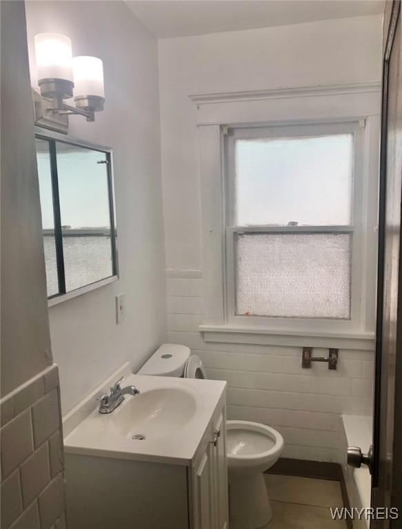 11 Verdun Ave, Buffalo, NY 14214 - bathroom with vanity, toilet, plenty of natural light, and a chandelier