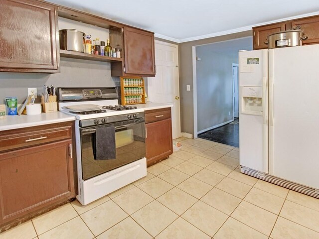 1459 Culver Rd, Rochester, NY 14609 - kitchen featuring white appliances, light countertops, light tile patterned floors, crown molding, and open shelves