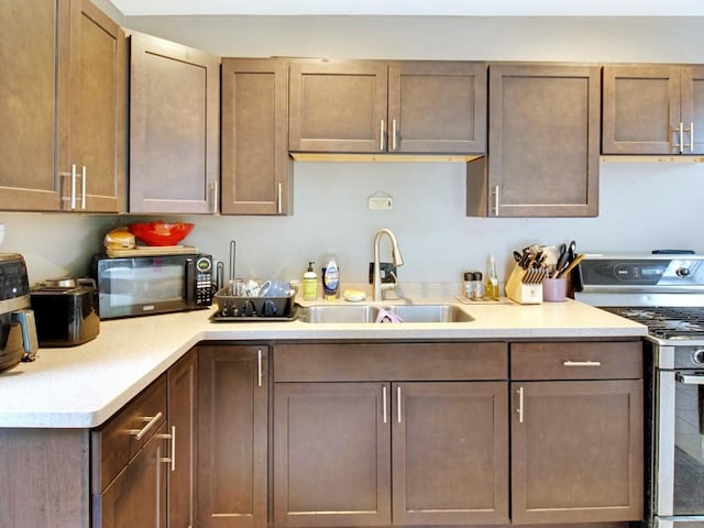 1459 Culver Rd, Rochester, NY 14609 - kitchen featuring stainless steel gas range, black microwave, and light countertops