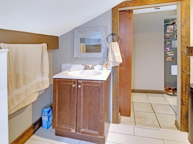 1459 Culver Rd, Rochester, NY 14609 - bathroom with vaulted ceiling, vanity, and tile patterned floors
