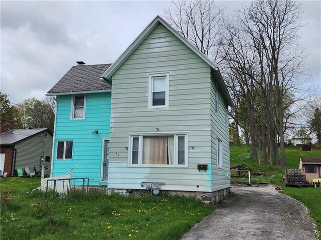 98 Gardeau St, Perry, NY 14530 - rear view of house with a lawn and a shingled roof