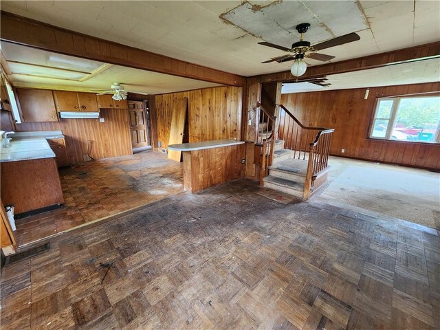 98 Gardeau St, Perry, NY 14530 - kitchen with wooden walls, brown cabinetry, ceiling fan, a peninsula, and light countertops