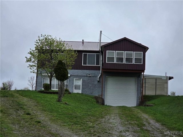 9600 Vermont View Rd, Machias, NY 14101 - back of property with driveway, a garage, brick siding, and a yard