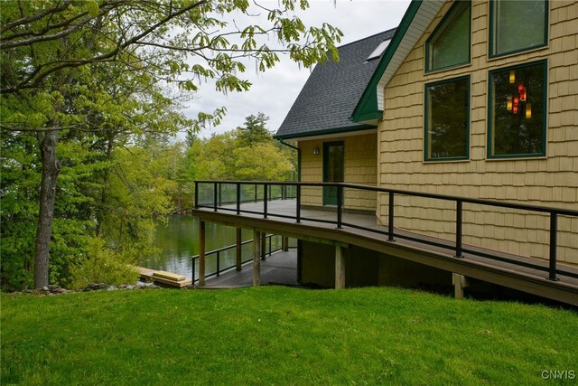 20172 Blue Heron Ln, Alexandria, NY 13607 - view of home's exterior featuring a yard, a shingled roof, and a deck with water view