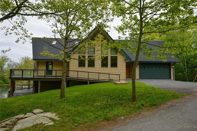 20172 Blue Heron Ln, Alexandria, NY 13607 - view of front of house featuring roof with shingles, gravel driveway, a garage, a front lawn, and a deck