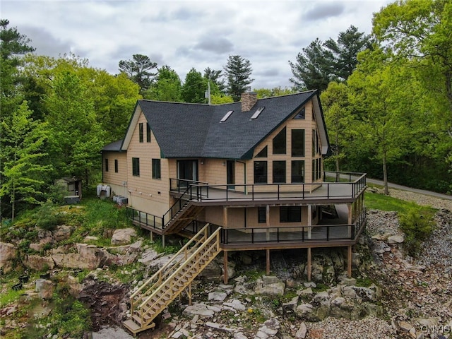 20172 Blue Heron Ln, Alexandria, NY 13607 - rear view of property with a deck, roof with shingles, a chimney, and stairs