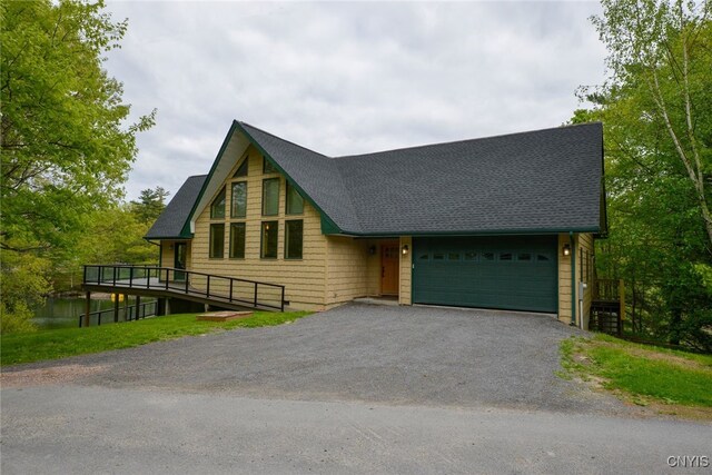 20172 Blue Heron Ln, Alexandria, NY 13607 - chalet / cabin featuring a garage, asphalt driveway, and a shingled roof