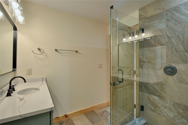 20172 Blue Heron Ln, Alexandria, NY 13607 - bathroom featuring vanity, a shower stall, and baseboards
