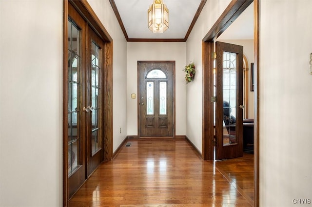 3503 Peterboro Rd, Vernon, NY 13421 - foyer entrance with french doors, hardwood / wood-style flooring, ornamental molding, baseboards, and arched walkways