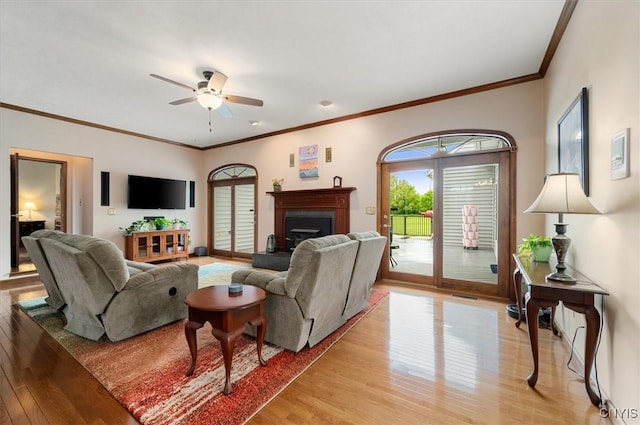 3503 Peterboro Rd, Vernon, NY 13421 - living room with light wood finished floors, a ceiling fan, a fireplace with raised hearth, crown molding, and baseboards