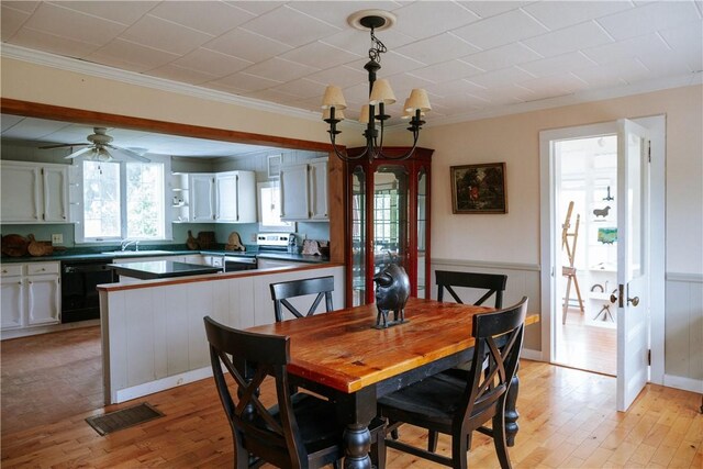 2400 Gladstone Hollow Rd, Andes, NY 13731 - dining area featuring ornamental molding, light wood-style floors, wainscoting, a ceiling fan, and a chandelier
