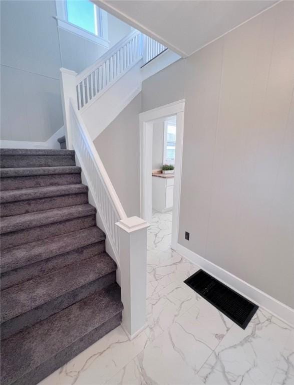 561 Post St, Elmira-City, NY 14904 - stairway featuring marble finish flooring, healthy amount of natural light, and baseboards