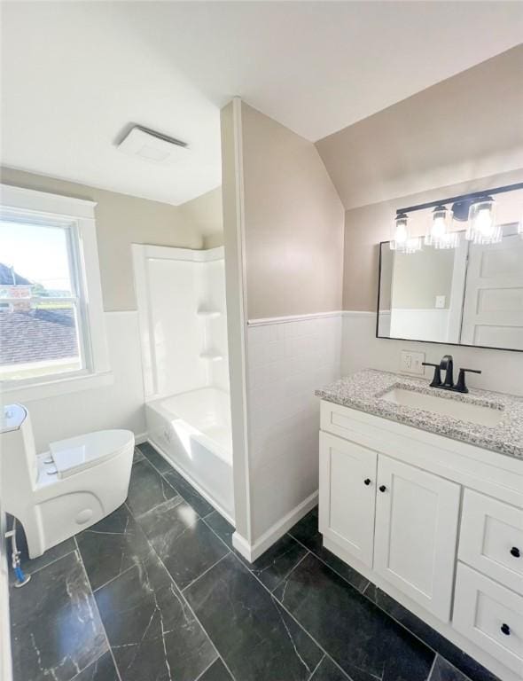 561 Post St, Elmira-City, NY 14904 - full bathroom featuring toilet, vanity, a wainscoted wall, marble finish floors, and washtub / shower combination