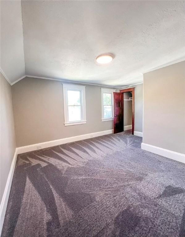 561 Post St, Elmira-City, NY 14904 - unfurnished bedroom with carpet, baseboards, vaulted ceiling, and a textured ceiling