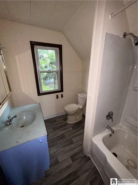 423 Plover St, Dunkirk-City, NY 14048 - full bathroom featuring wood finished floors, toilet, vanity, vaulted ceiling, and shower / washtub combination