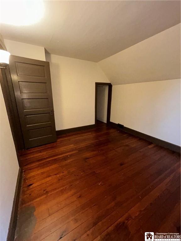 423 Plover St, Dunkirk-City, NY 14048 - additional living space featuring baseboards, dark wood-style floors, and lofted ceiling