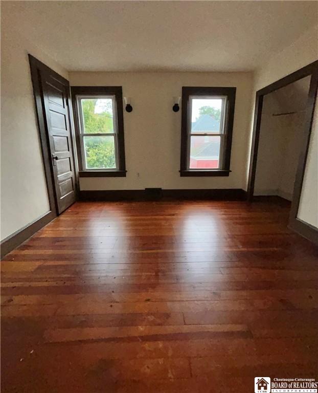 423 Plover St, Dunkirk-City, NY 14048 - spare room with dark wood-style floors and baseboards