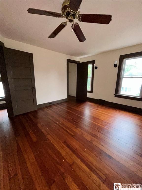 423 Plover St, Dunkirk-City, NY 14048 - unfurnished bedroom with wood-type flooring, baseboards, and a ceiling fan