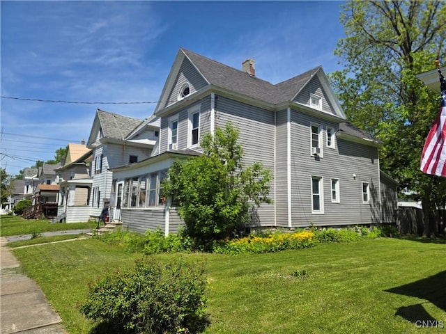 919 Academy St, Watertown-City, NY 13601 - view of property exterior with a yard, a chimney, and a shingled roof