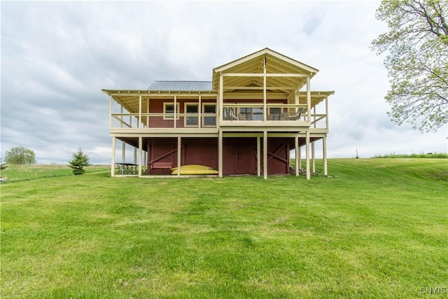 4146 Carleton Island Rd Unit 1, Cape Vincent, NY 13618 - back of house with a lawn, a deck, and metal roof
