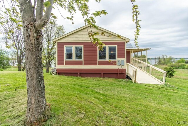 4146 Carleton Island Rd Unit 1, Cape Vincent, NY 13618 - back of property featuring a lawn
