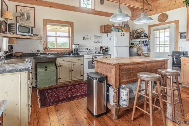 4146 Carleton Island Rd Unit 1, Cape Vincent, NY 13618 - kitchen with white appliances, a sink, beamed ceiling, light wood-type flooring, and healthy amount of natural light