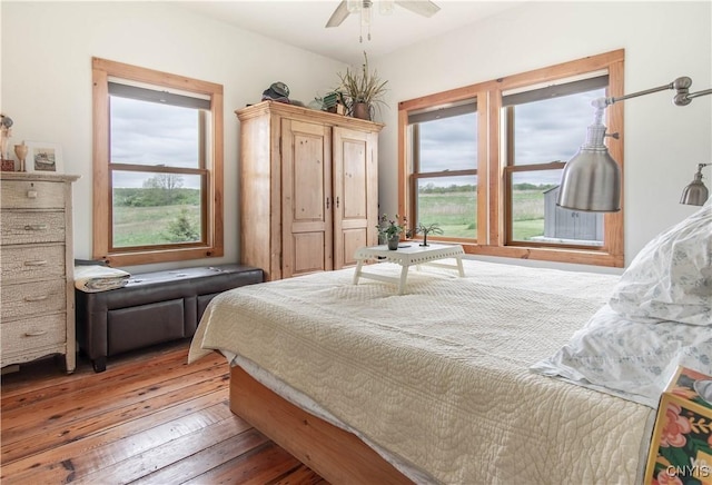 4146 Carleton Island Rd Unit 1, Cape Vincent, NY 13618 - bedroom featuring multiple windows, wood-type flooring, and a ceiling fan