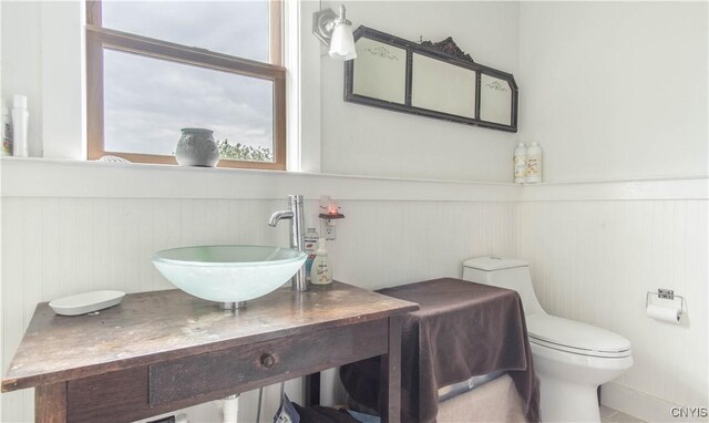 4146 Carleton Island Rd Unit 1, Cape Vincent, NY 13618 - bathroom featuring a wainscoted wall, toilet, and vanity