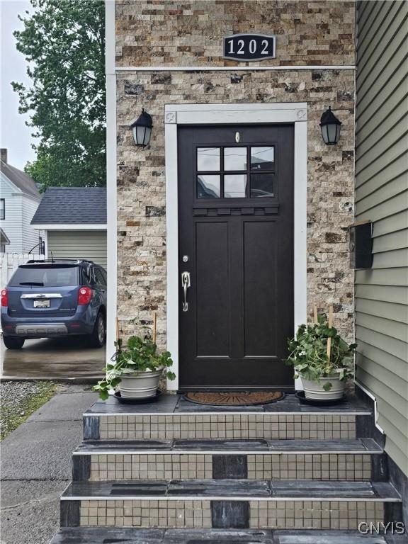 1202 Mary St, Utica, NY 13501 - view of exterior entry featuring stone siding