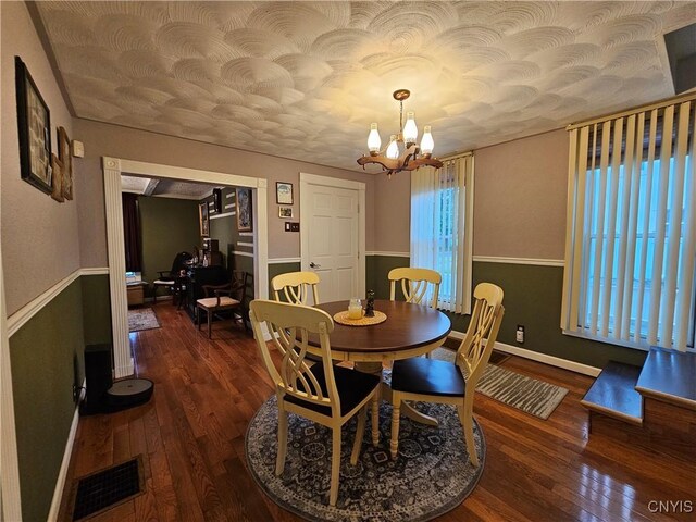 1202 Mary St, Utica, NY 13501 - dining room with wood finished floors, a chandelier, and baseboards