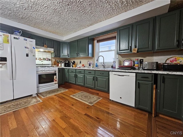 1202 Mary St, Utica, NY 13501 - kitchen featuring white appliances, under cabinet range hood, a sink, hardwood / wood-style floors, and a textured ceiling