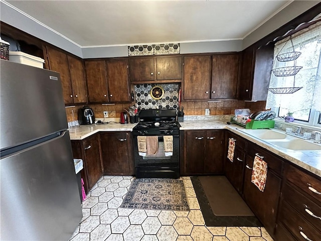 104 Newcomb St, Rochester, NY 14609 - kitchen featuring freestanding refrigerator, black gas range, a sink, light countertops, and dark brown cabinets