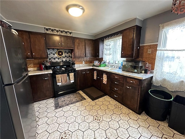 104 Newcomb St, Rochester, NY 14609 - kitchen featuring gas stove, freestanding refrigerator, light countertops, and dark brown cabinets