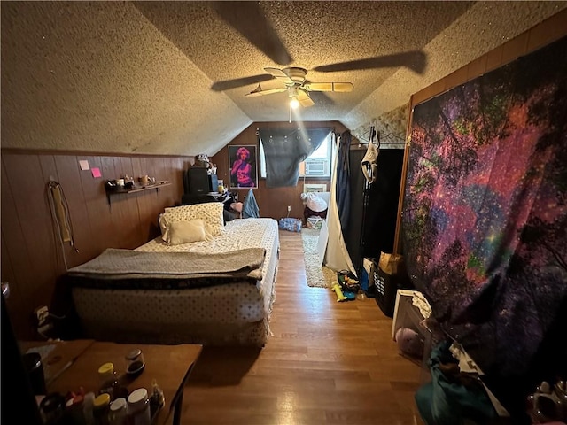 104 Newcomb St, Rochester, NY 14609 - bedroom with a textured ceiling, wood finished floors, vaulted ceiling, wooden walls, and a ceiling fan