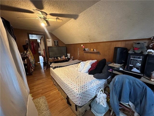 104 Newcomb St, Rochester, NY 14609 - bedroom with wood finished floors, vaulted ceiling, a textured ceiling, a ceiling fan, and wood walls