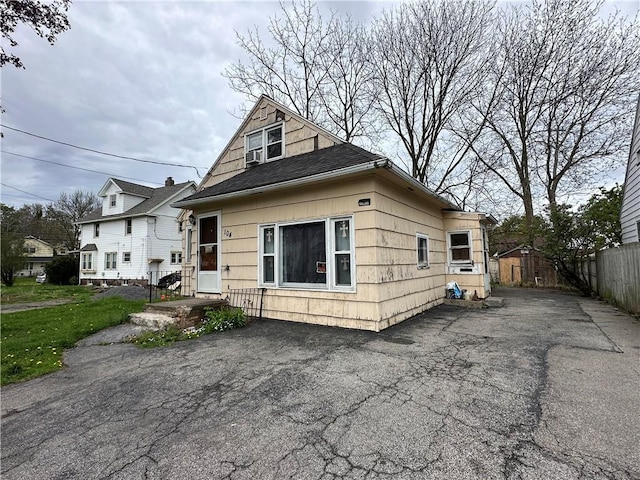 104 Newcomb St, Rochester, NY 14609 - view of front facade featuring driveway and roof with shingles
