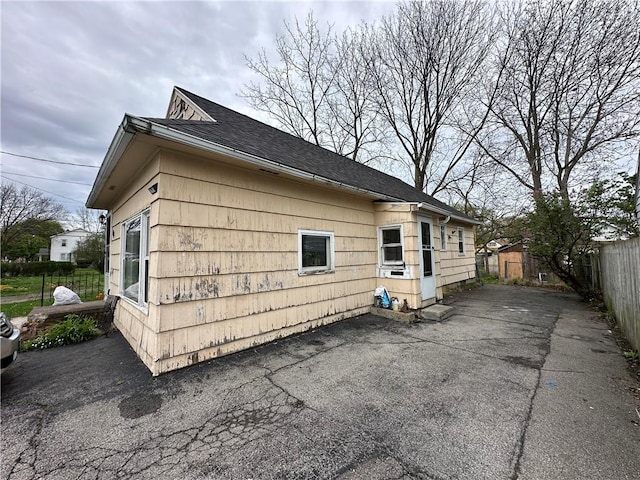 104 Newcomb St, Rochester, NY 14609 - view of home's exterior with a patio and a shingled roof