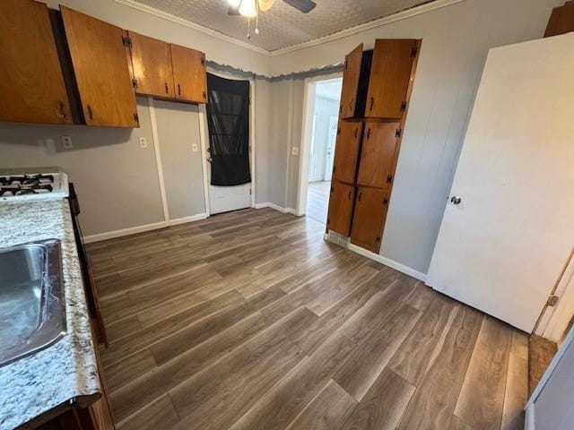 322 Grand Ave, Rochester, NY 14609 - kitchen featuring ornamental molding, brown cabinetry, dark wood finished floors, light countertops, and ceiling fan