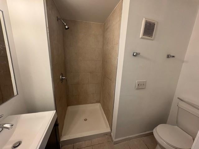322 Grand Ave, Rochester, NY 14609 - bathroom with tile patterned floors, toilet, tiled shower, and vanity