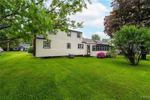 114 E Dauenhauer St, Manlius, NY 13057 - back of property with entry steps, a yard, cooling unit, and roof with shingles
