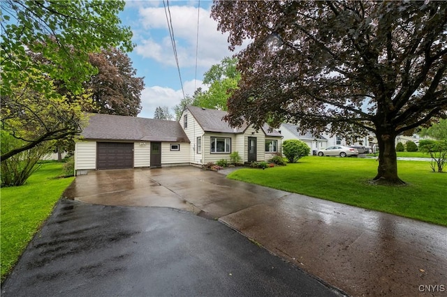 114 E Dauenhauer St, Manlius, NY 13057 - view of front of home featuring driveway, a front yard, and a garage