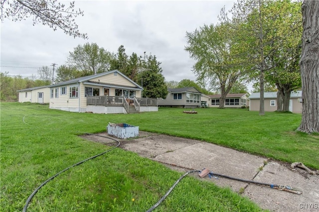 2510 Ponds Shore Dr, Cape Vincent, NY 13618 - back of property featuring a lawn and a deck