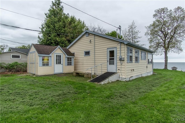 2510 Ponds Shore Dr, Cape Vincent, NY 13618 - back of house featuring a lawn and an outbuilding