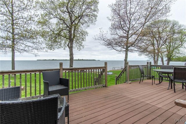 2510 Ponds Shore Dr, Cape Vincent, NY 13618 - deck with a water view, a lawn, and outdoor dining space