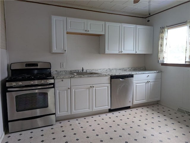 56 Aurora Ave, West Seneca, NY 14224 - kitchen with appliances with stainless steel finishes, a sink, light flooring, white cabinetry, and light stone countertops
