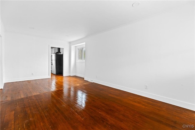 1310 Oak St, Utica, NY 13502 - unfurnished room featuring baseboards and hardwood / wood-style floors