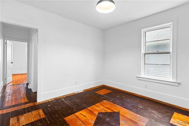 1310 Oak St, Utica, NY 13502 - spare room with dark wood finished floors and baseboards