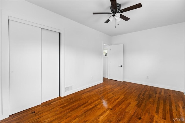 1310 Oak St, Utica, NY 13502 - unfurnished bedroom with a closet, wood finished floors, baseboards, and ceiling fan