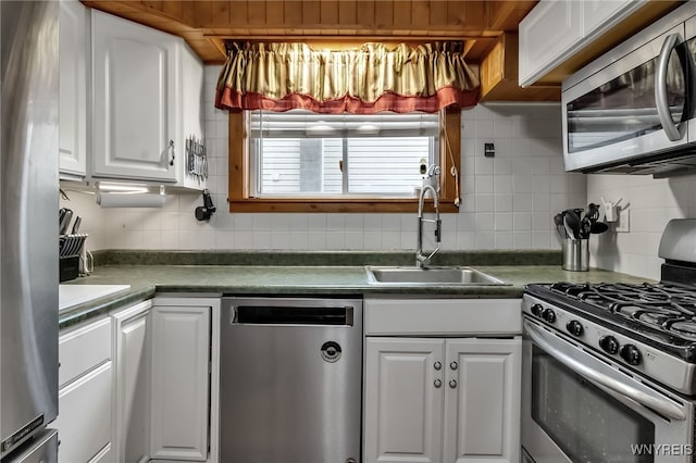 18 Spruce St, Lockport-City, NY 14094 - kitchen with stainless steel appliances, a sink, backsplash, and white cabinetry
